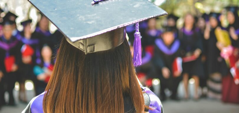 woman wearing academic cap and dress selective focus photography